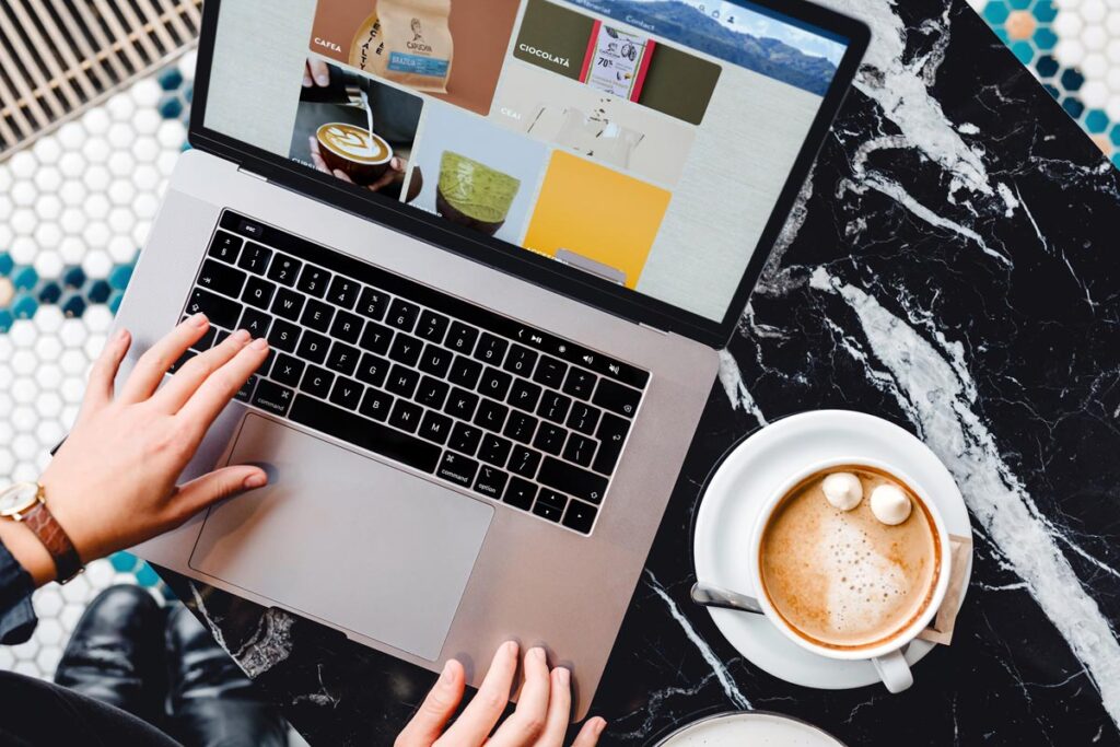 Capuchin website mockup on laptop at a cafe